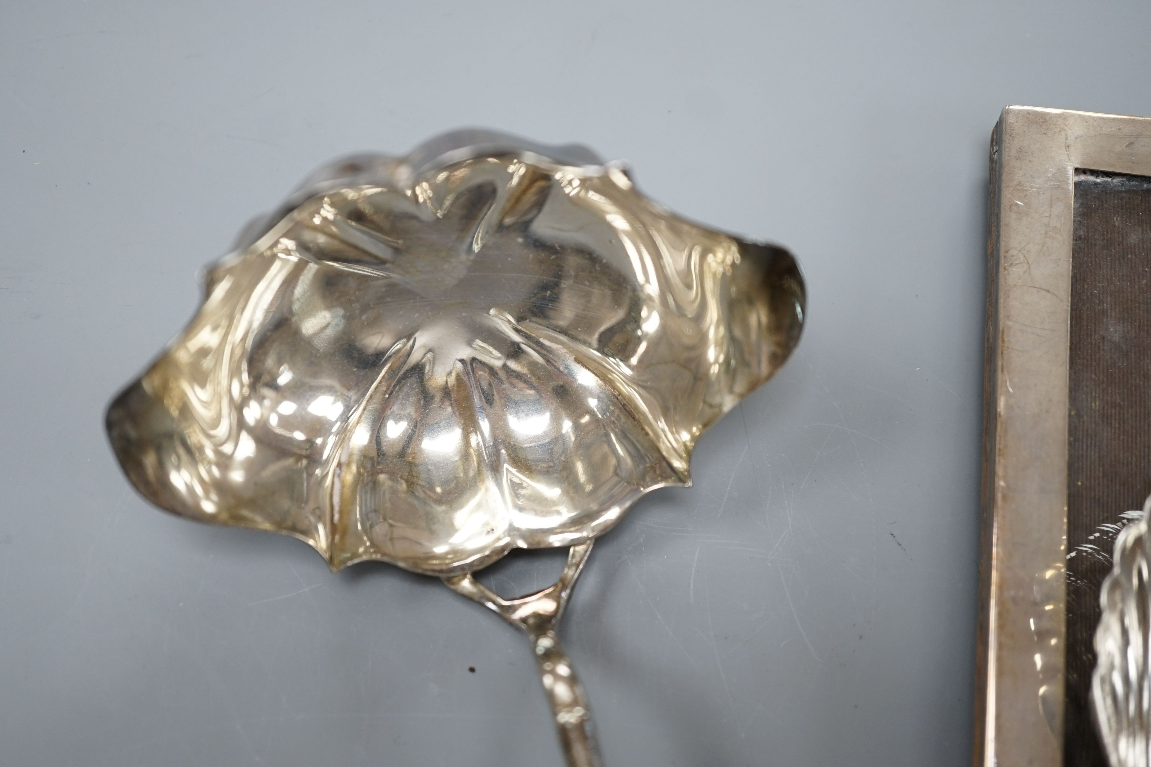 A Georgian style silver toddy ladle, London 1976, a silver mounted rectangular photograph frame, a caddy spoon, and a vesta case stamped Sterling